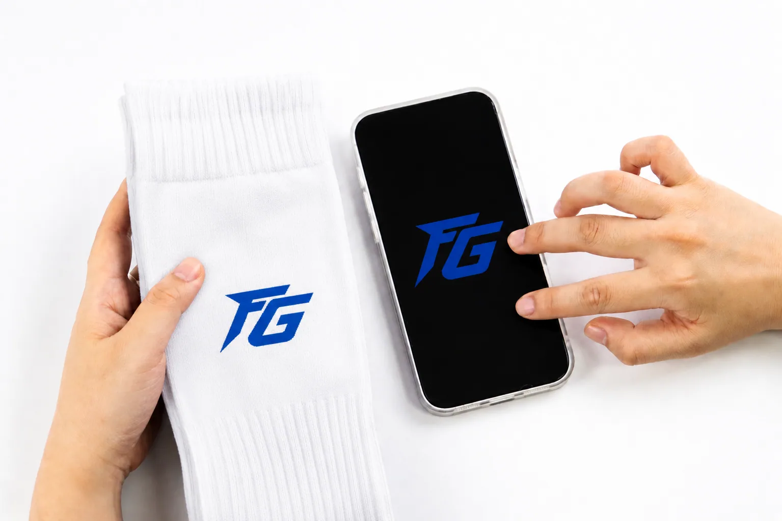 Custom sock sample compared with digital logo artwork during development