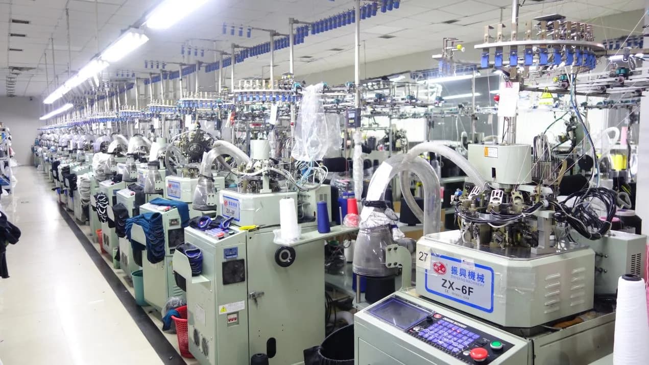 Custom socks being knitted on computerized machines during bulk production