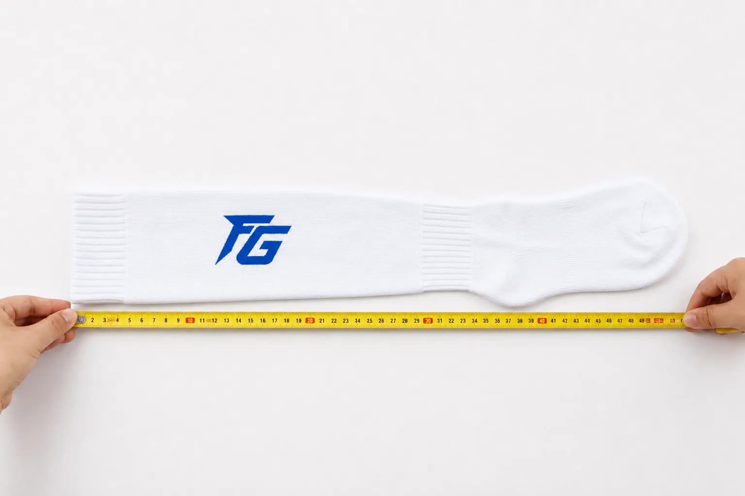 Custom sock measured during quality inspection before packing