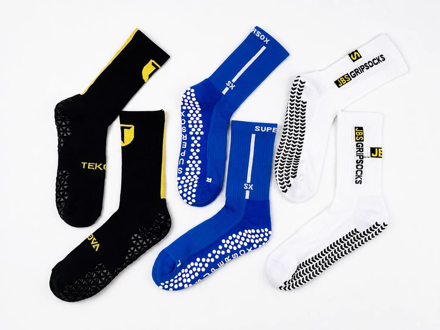 Black, blue and white private label grip socks with custom knitted logos and sole patterns