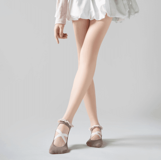 Barre studio model wearing cross-strap grip socks