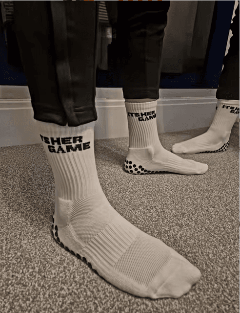 Football academy players wearing custom white grip socks with silicone sole coverage