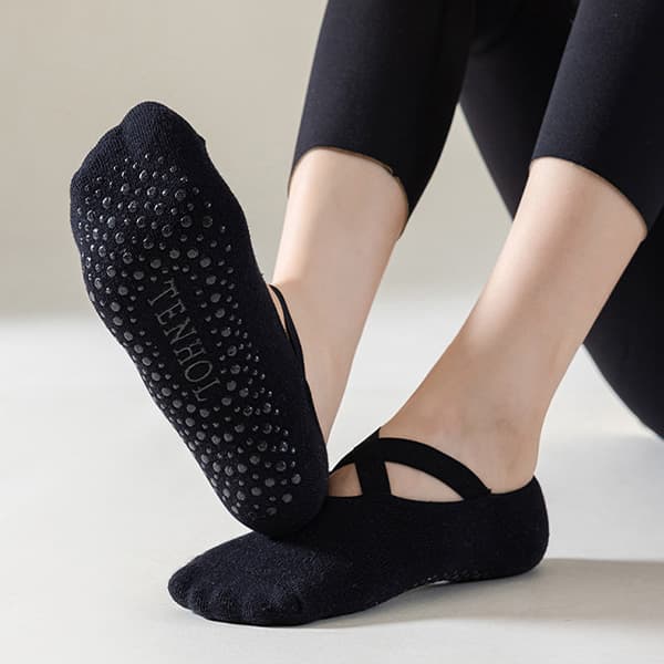 Model wearing black non-slip yoga and Pilates grip socks