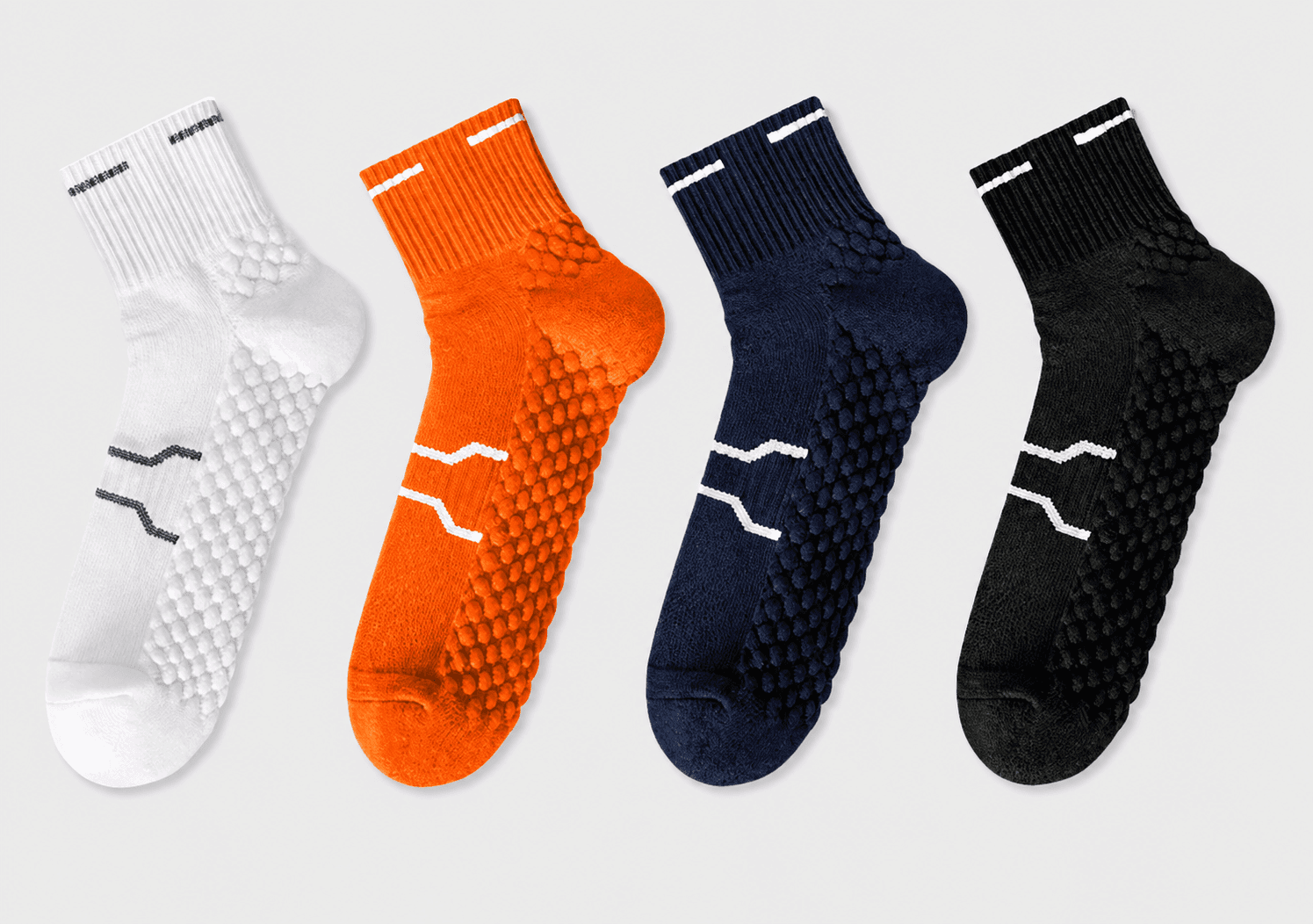 Four custom running club socks in white, orange, navy and black team colorways