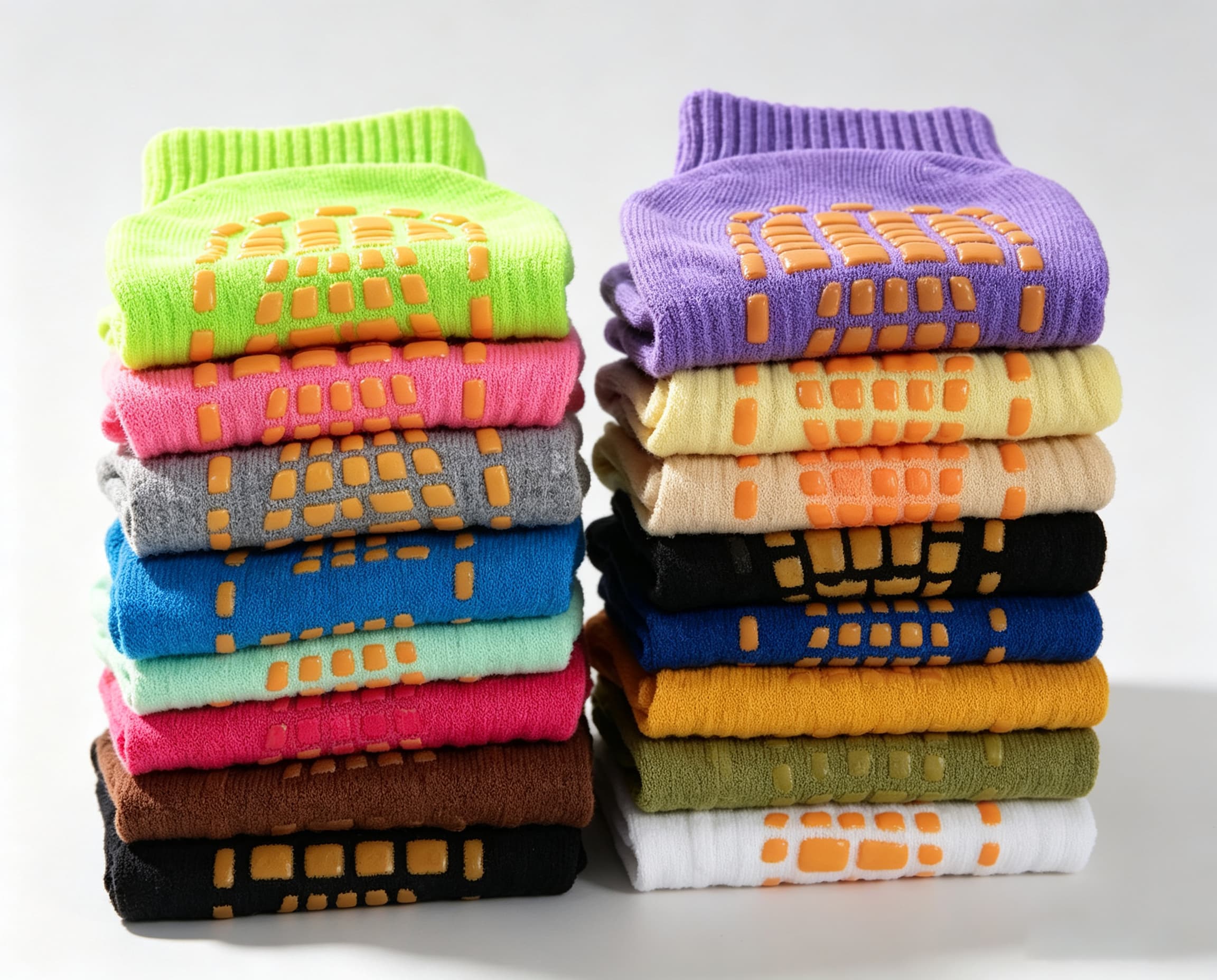 Stacks of color-coded trampoline grip socks prepared for repeat supply