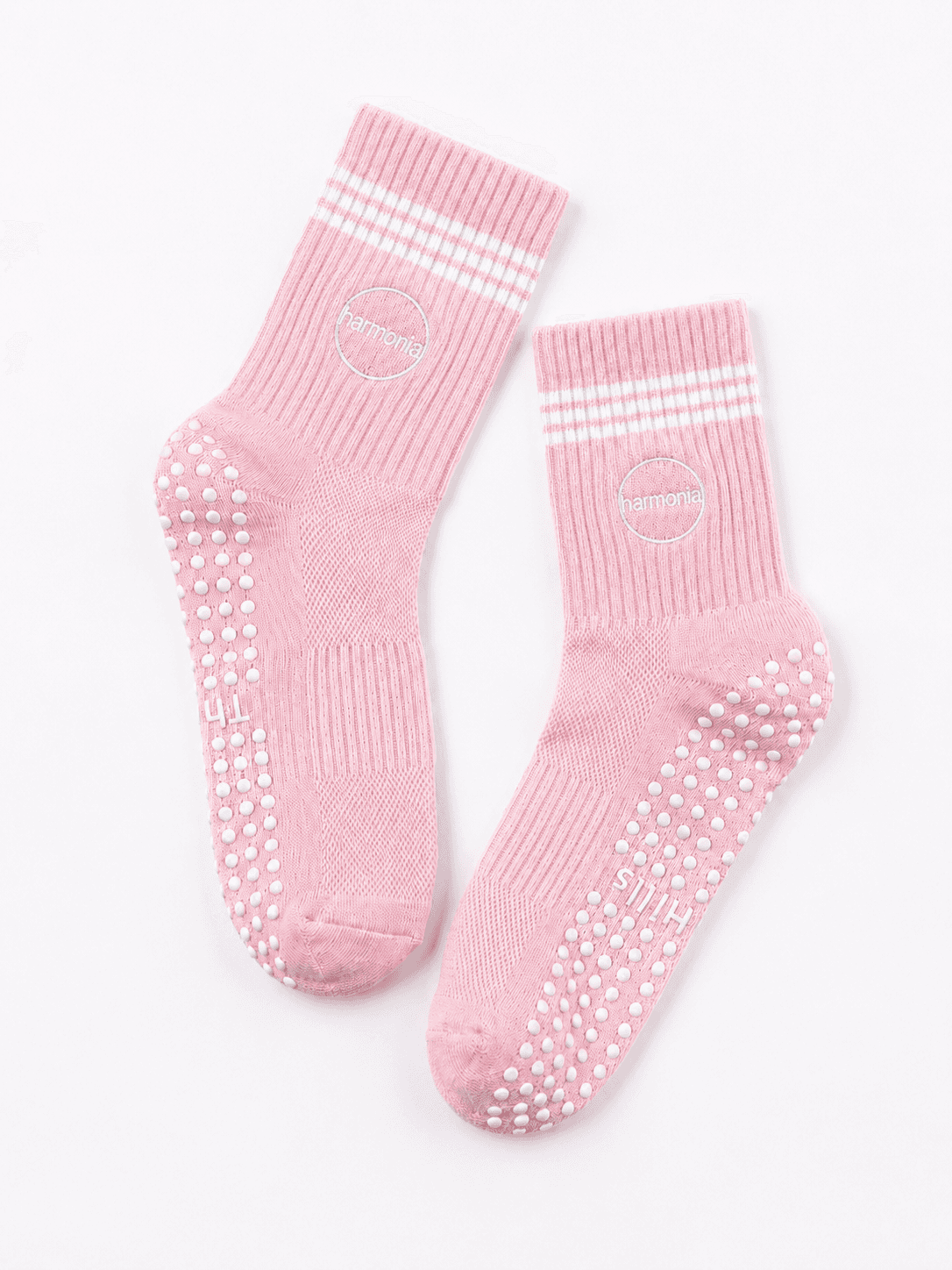 Pair of pink custom Pilates socks with embroidered cuff logos and silicone grips