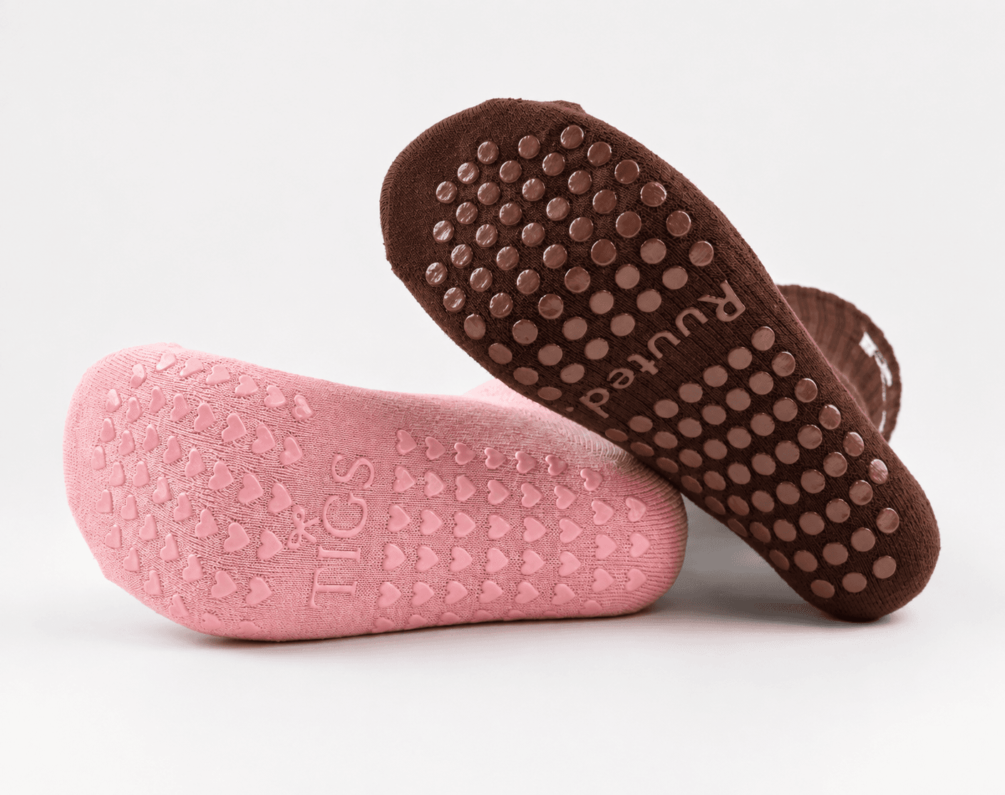 Heart and circular Pilates sock grip patterns with custom silicone branding