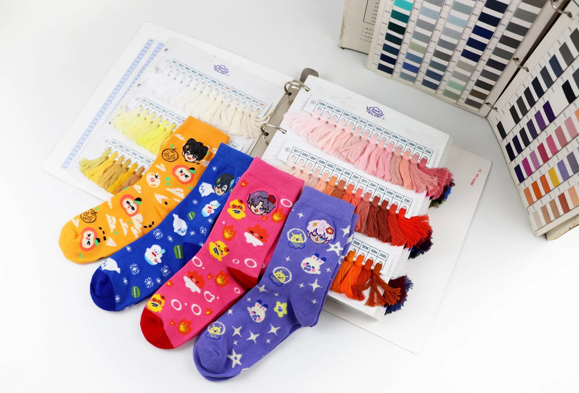 Custom colorful socks displayed with yarn color swatches for material and color selection