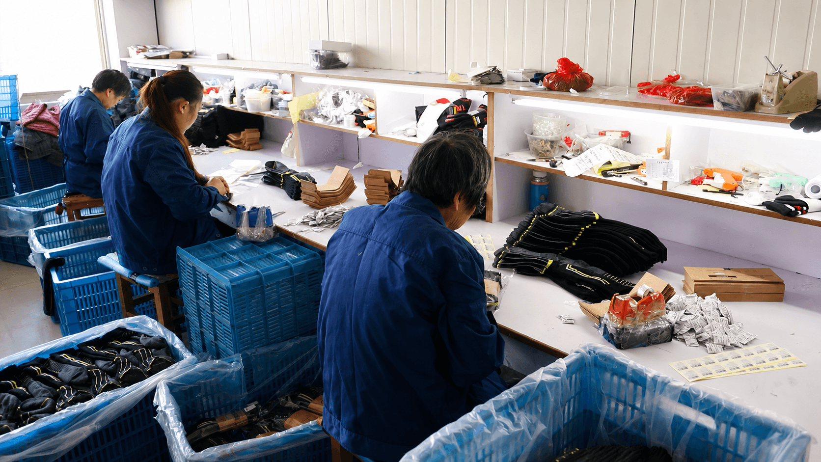 Factory team completing sock finishing labeling and visual quality checks