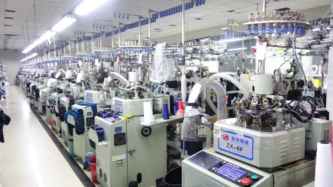 Computerized sock knitting machines across the PeakMotion production floor